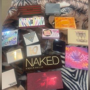 Several eyeshadow pallets in different colors and sizes